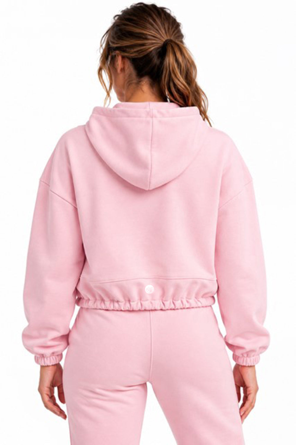 Pink cropped oversized hoodie worn by a model, back view against a white background