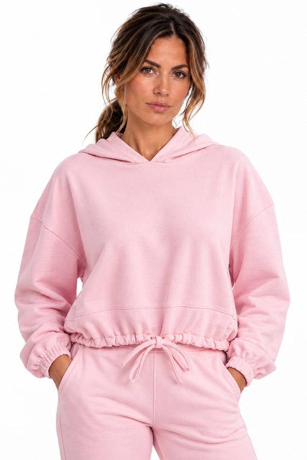 Pink cropped oversized hoodie worn by a model, front view against a white background