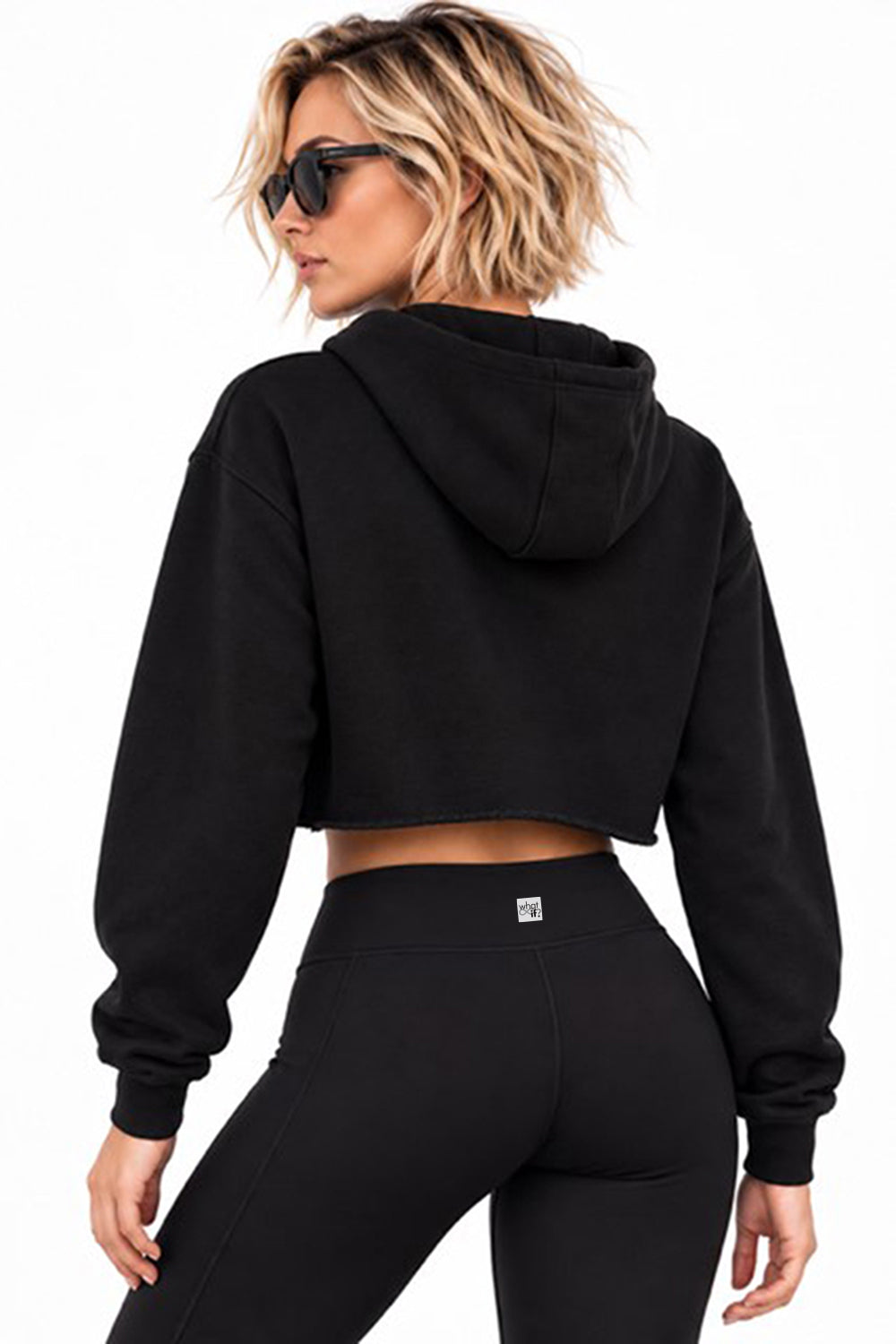 Black cropped fleece hoodie worn by a model, back view against a white background