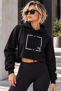 Black cropped fleece hoodie worn by a model, front view