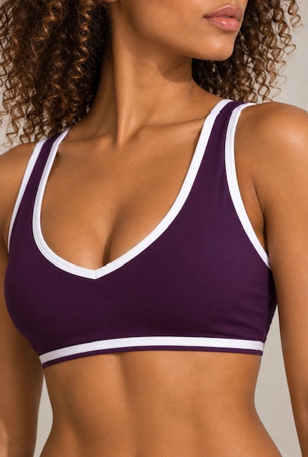 Purple sports bra with white trim, front close-up